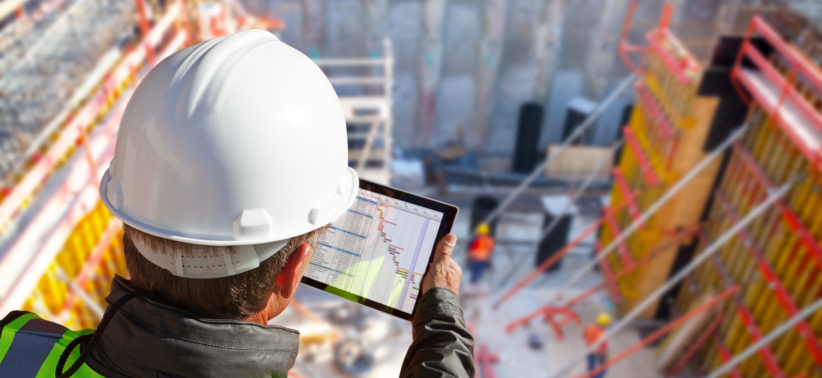 Hard hat employee observing workers in warehouse 