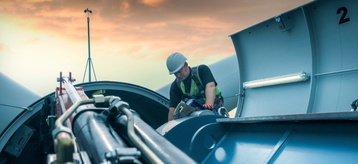 Photo of a person servicing a wind turbine