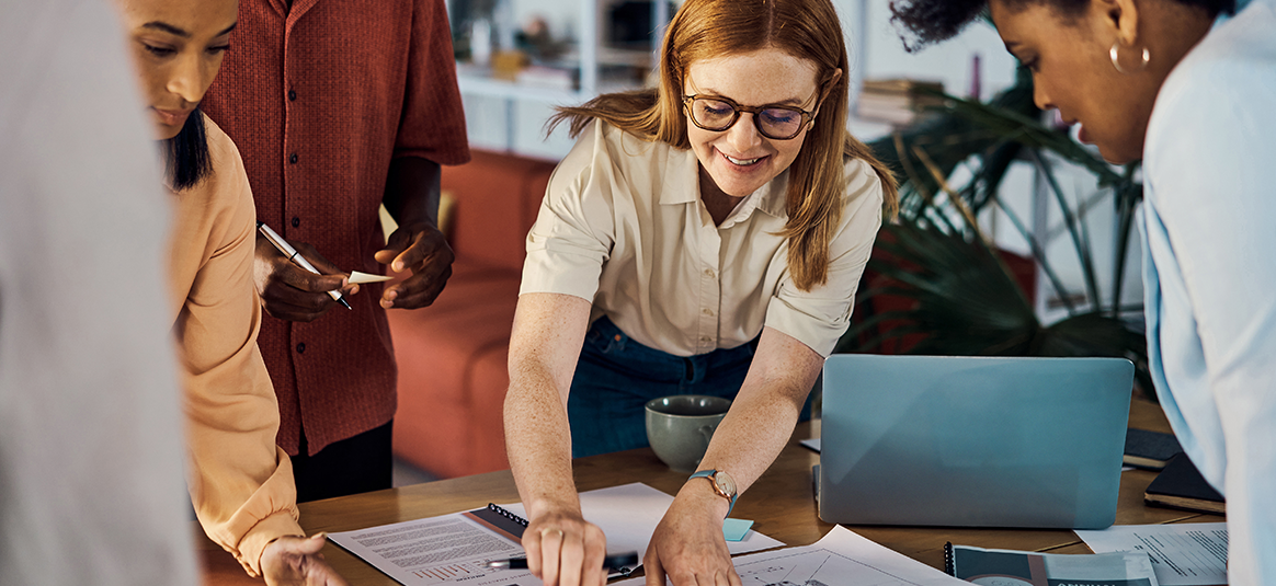 Photo of people planning on paper around a desk