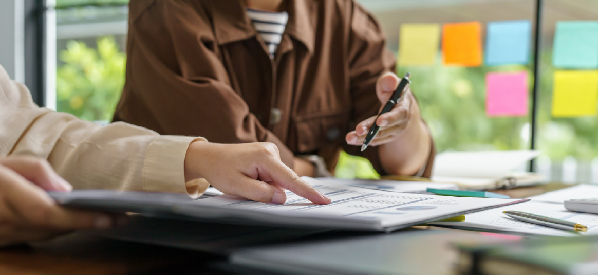 Photo of two people working on a document