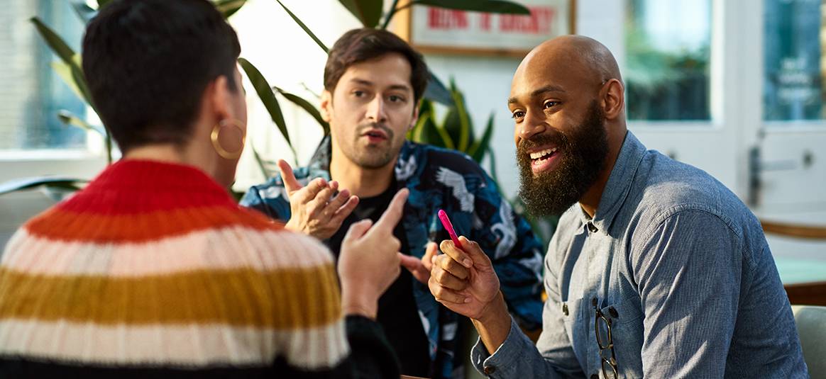Photo of three people holding a meeing