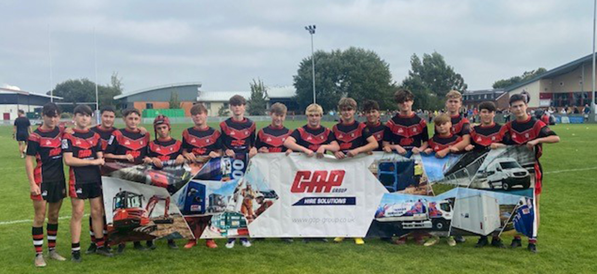Photo of a sports team holding a GAP banner Photo of a sports team holding a GAP banner