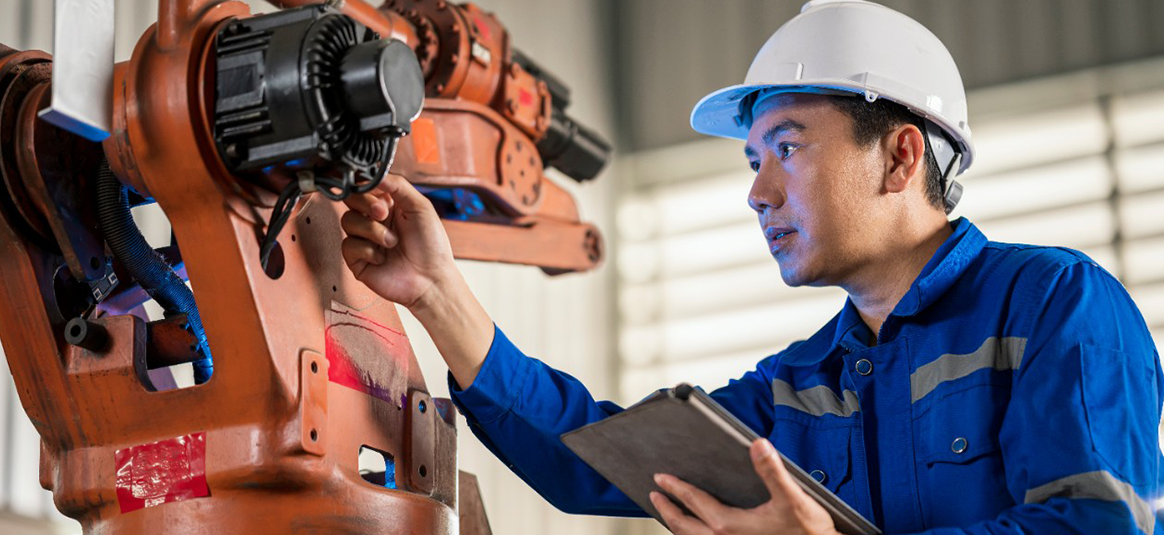 A hard hat worker conducting a machine review