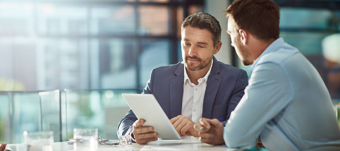 Two workers having a meeting around a table
