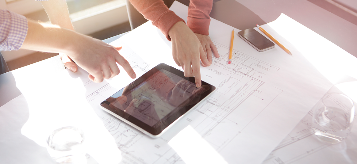 Close-up photo of people using a tablet device together