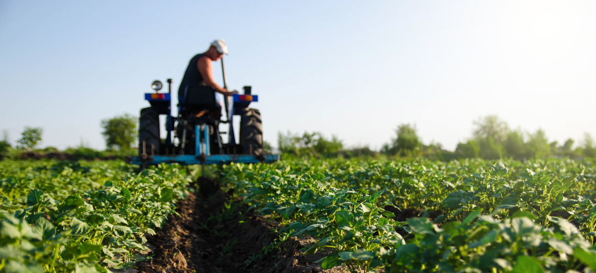 Photo of a farmer on a tractor in a field