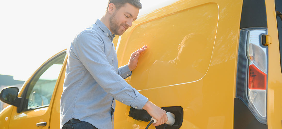 A man charging his electric van at a charge point