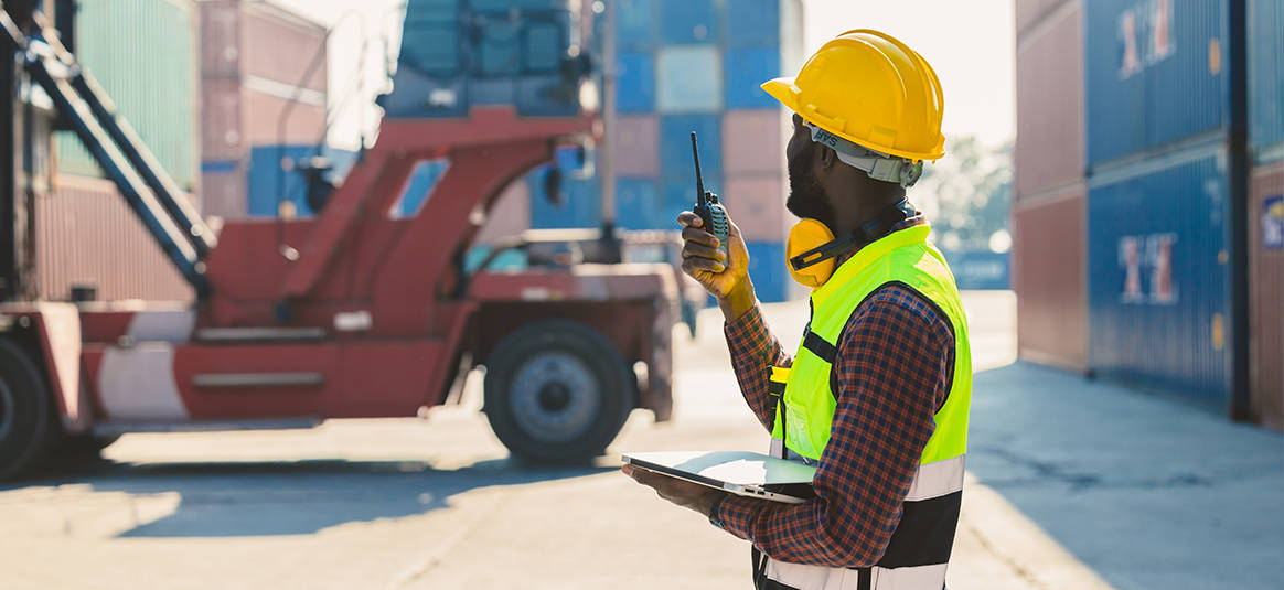 Man holding a walkie talkie Man holding a walkie talkie